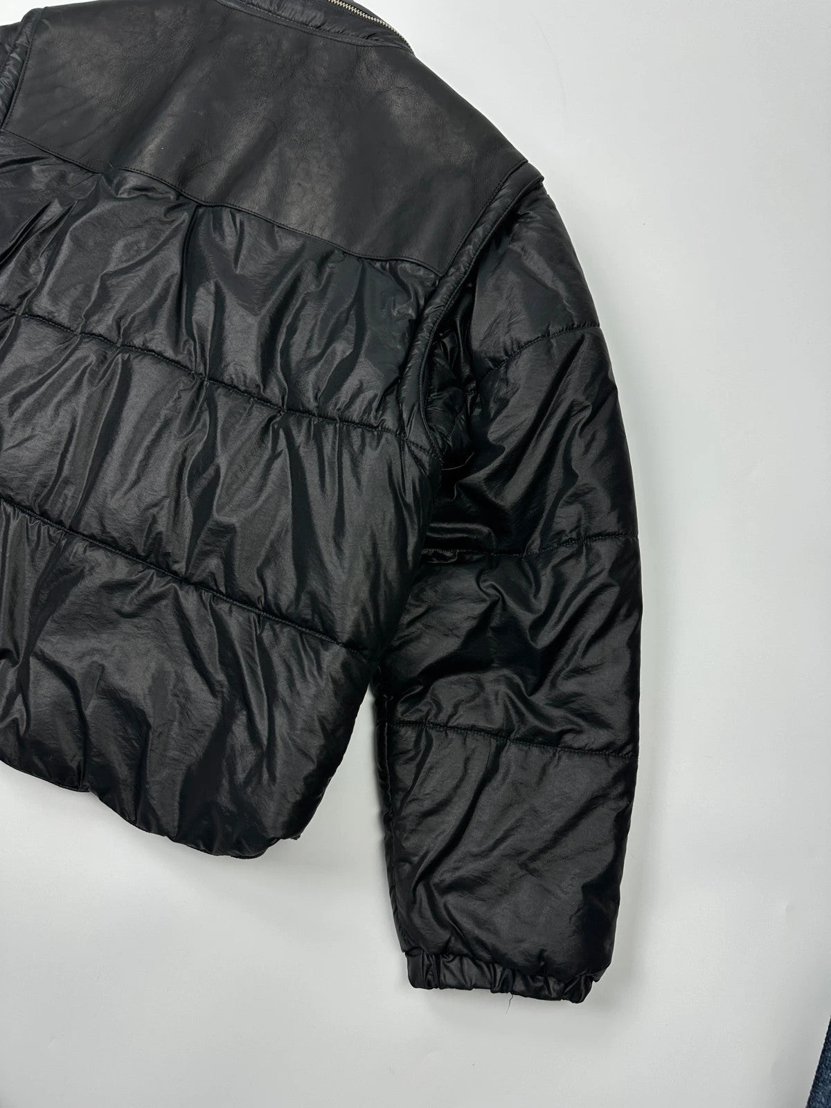Armani black puffer bomber jacket, leather and nylon, removable sleeves, vintage 90s style.