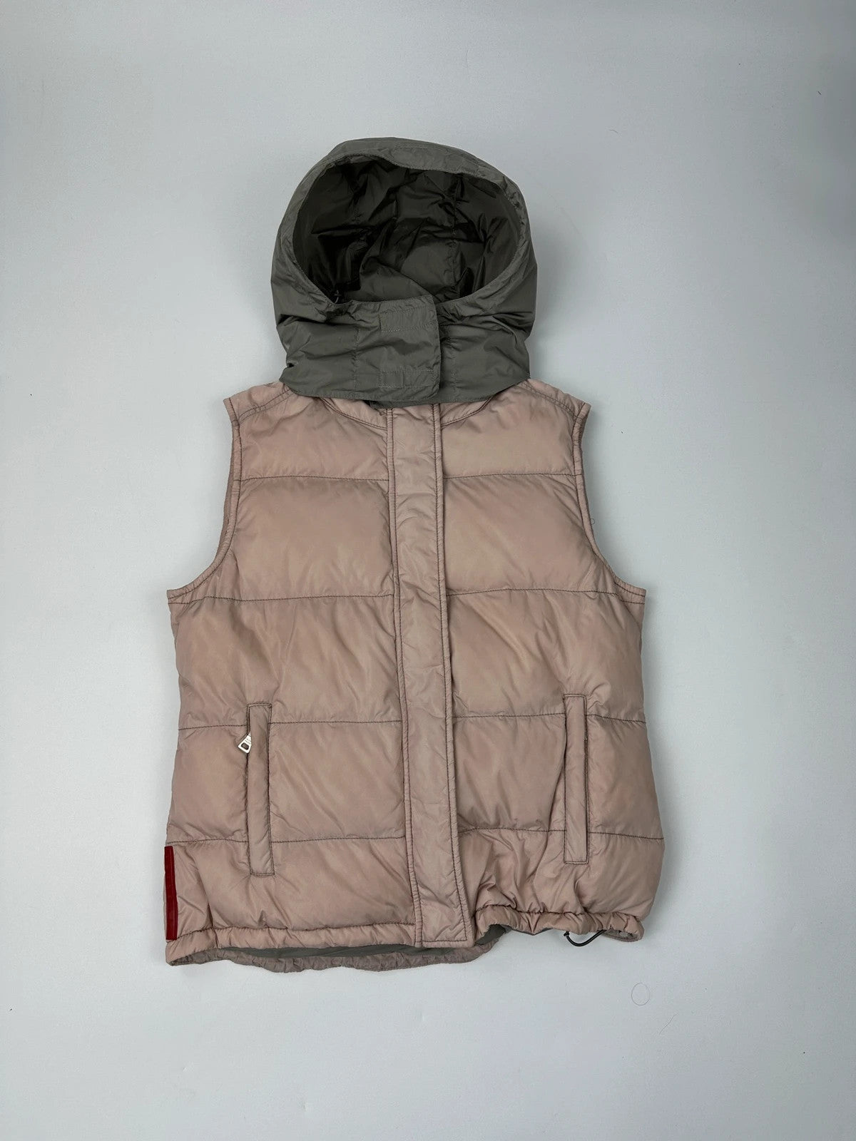 Prada orange and pink puffer vest with retractable hood and logo detailing.