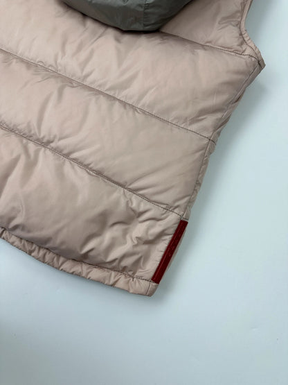 Prada orange and pink puffer vest with retractable hood and logo detailing.