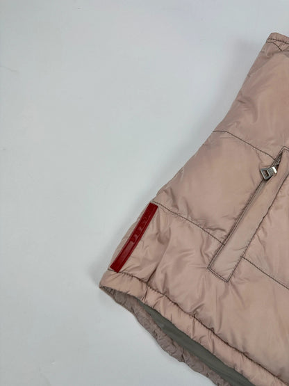 Prada orange and pink puffer vest with retractable hood and logo detailing.