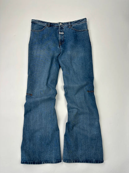 Marithé François Girbaud blue denim flared jeans with twisted design and vintage 90s style.
