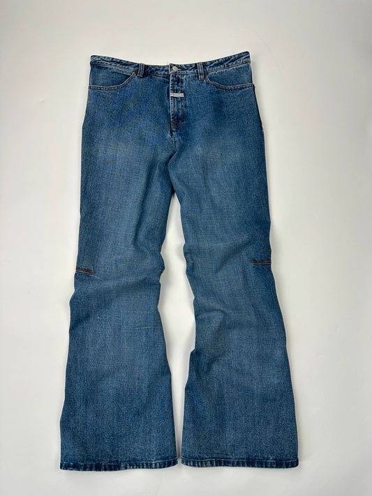 Marithé François Girbaud blue denim flared jeans with twisted design and vintage 90s style.