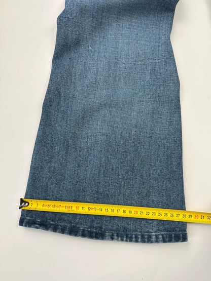 Marithé François Girbaud blue denim flared jeans with twisted design and vintage 90s style.