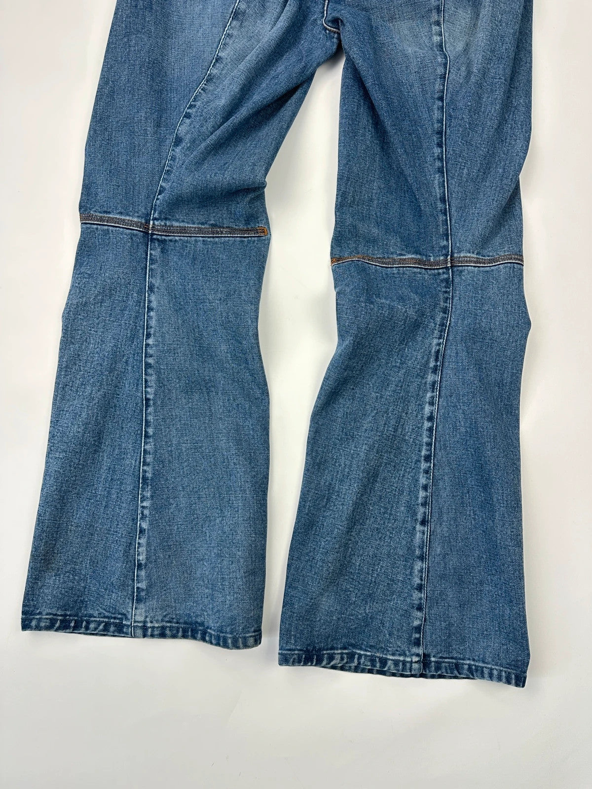 Marithé François Girbaud blue denim flared jeans with twisted design and vintage 90s style.