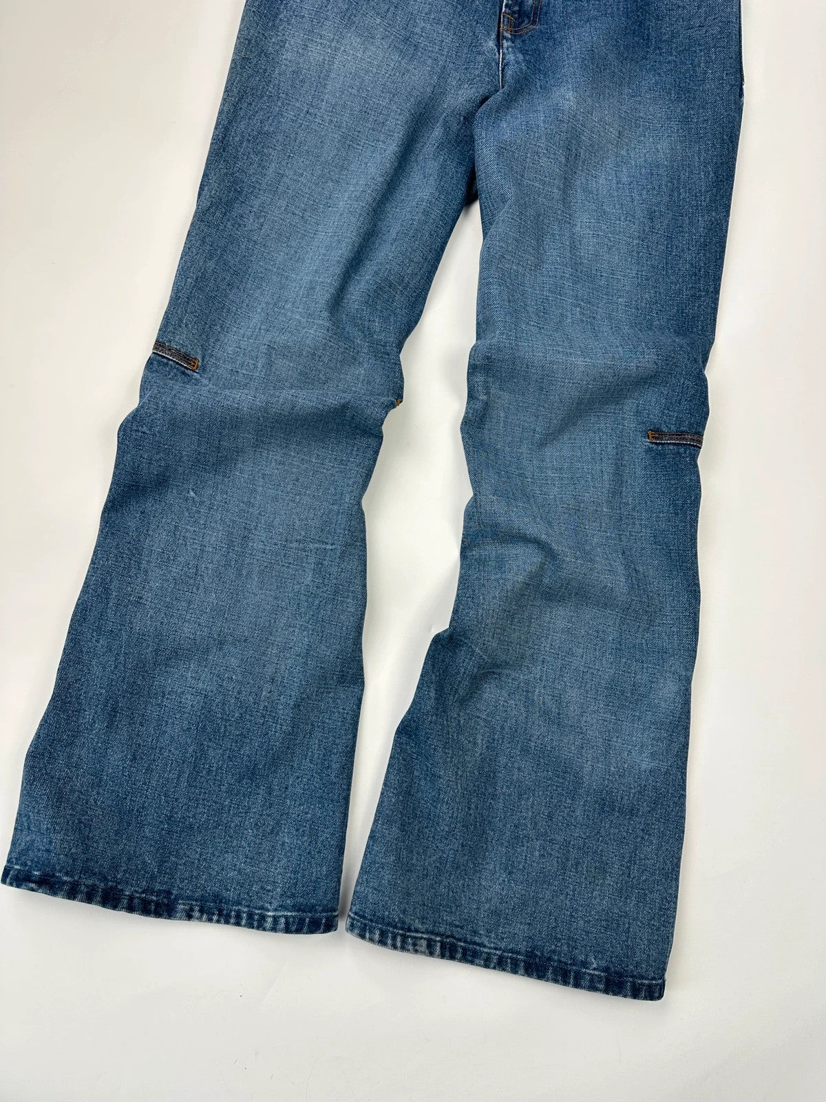 Marithé François Girbaud blue denim flared jeans with twisted design and vintage 90s style.