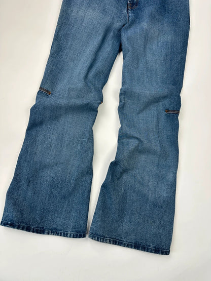 Marithé François Girbaud blue denim flared jeans with twisted design and vintage 90s style.
