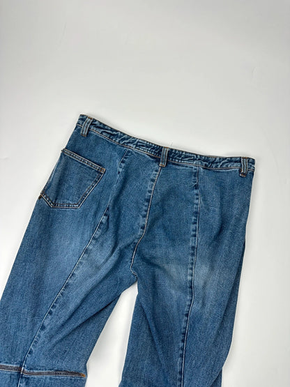 Marithé François Girbaud blue denim flared jeans with twisted design and vintage 90s style.