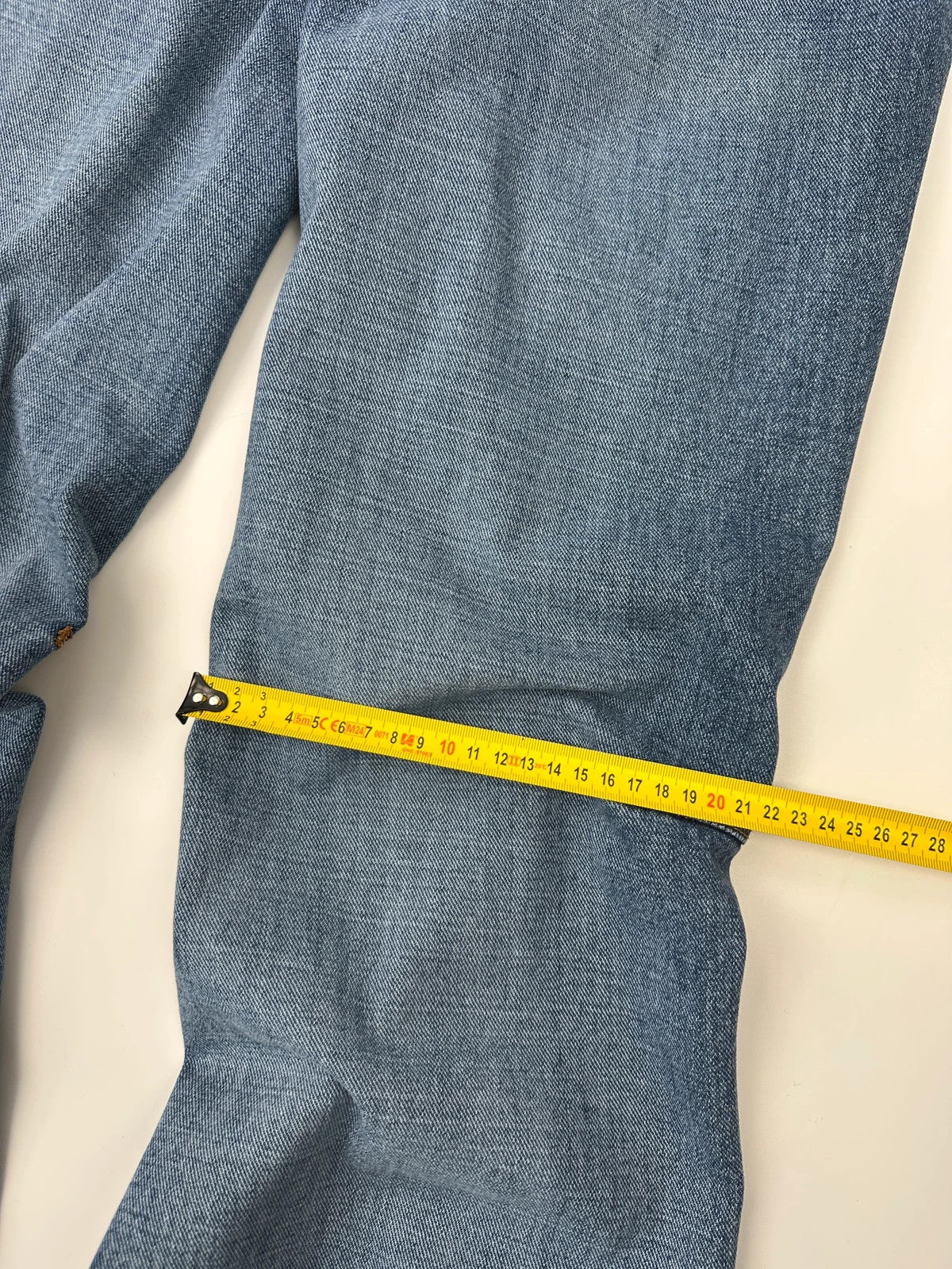 Marithé François Girbaud blue denim flared jeans with twisted design and vintage 90s style.