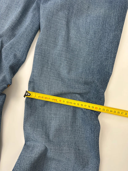 Marithé François Girbaud blue denim flared jeans with twisted design and vintage 90s style.