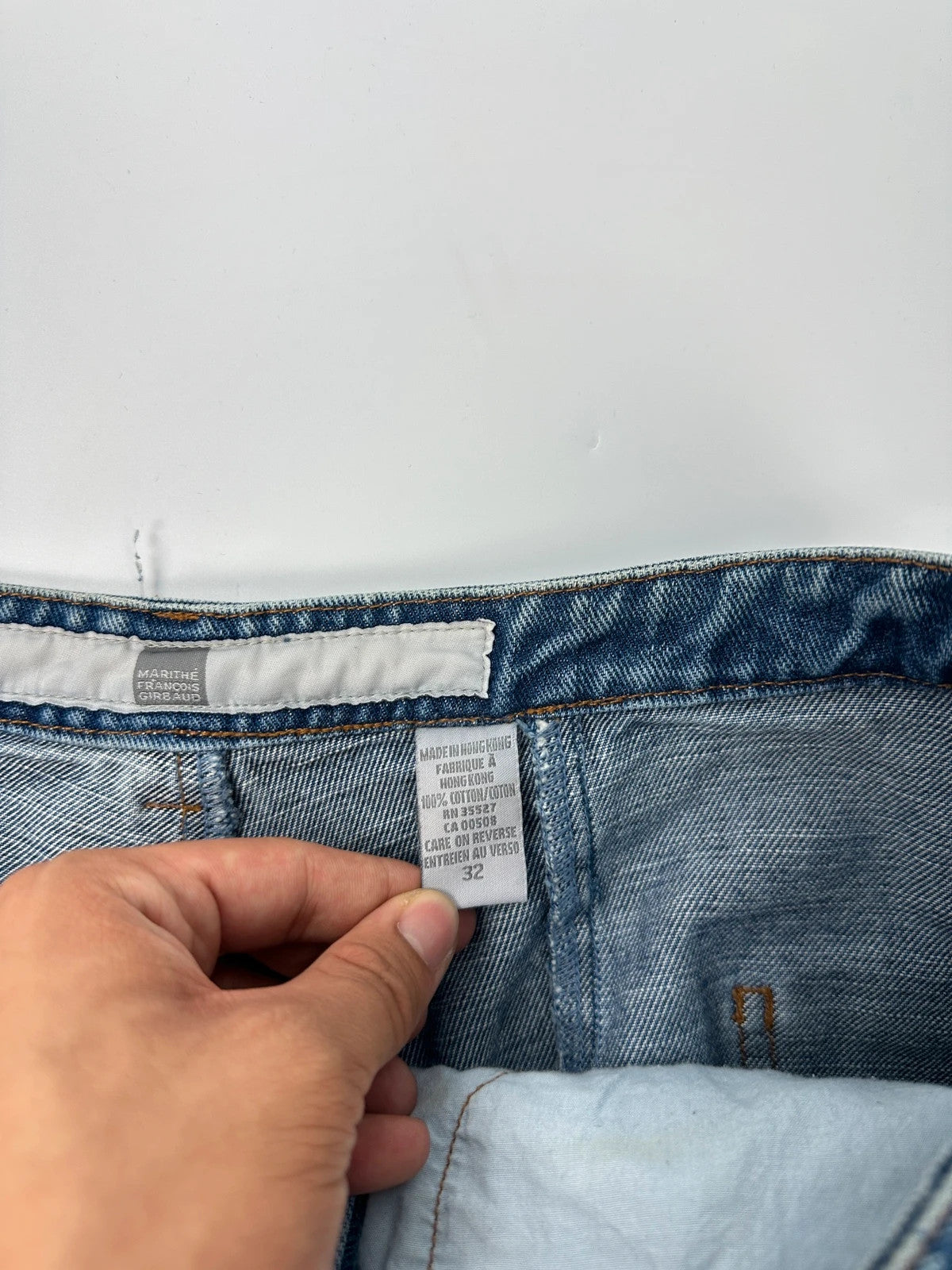 Marithé François Girbaud blue denim flared jeans with twisted design and vintage 90s style.