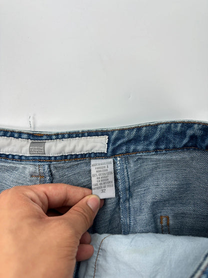 Marithé François Girbaud blue denim flared jeans with twisted design and vintage 90s style.