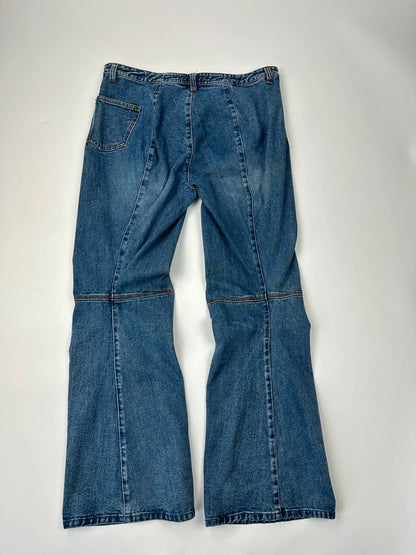 Marithé François Girbaud blue denim flared jeans with twisted design and vintage 90s style.