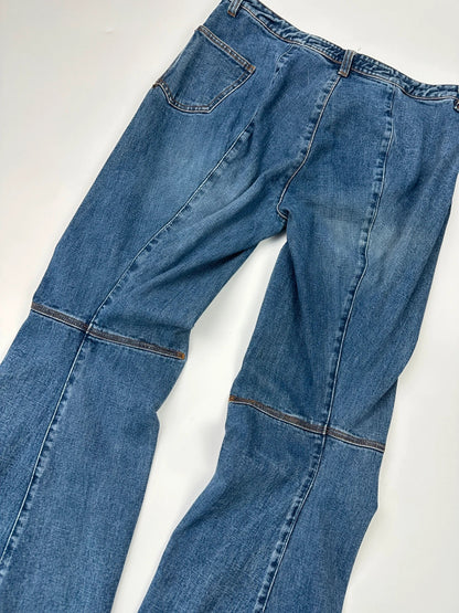 Marithé François Girbaud blue denim flared jeans with twisted design and vintage 90s style.