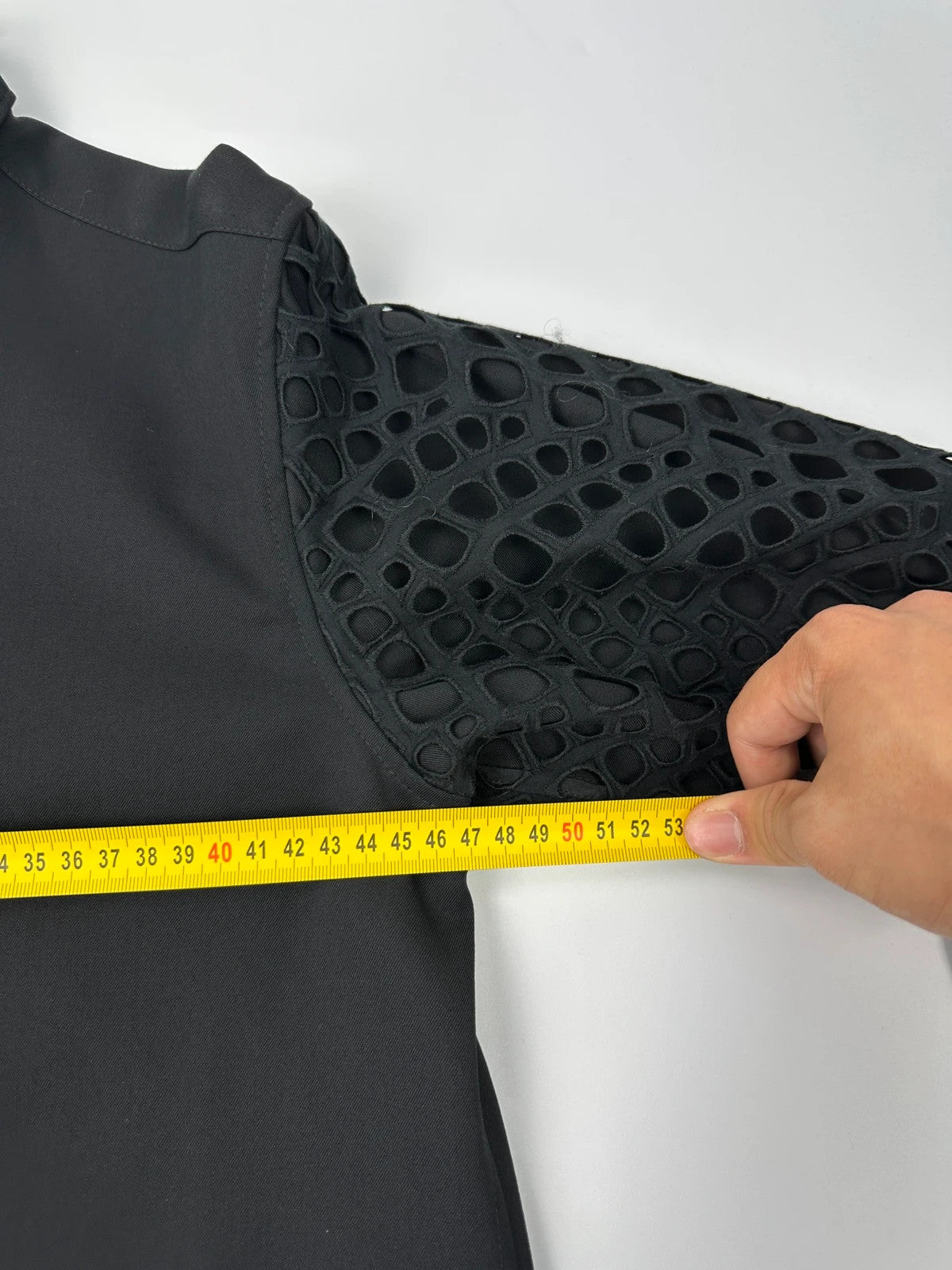 Y's by Yohji Yamamoto black shirt with mesh sleeves and subtle logo details.