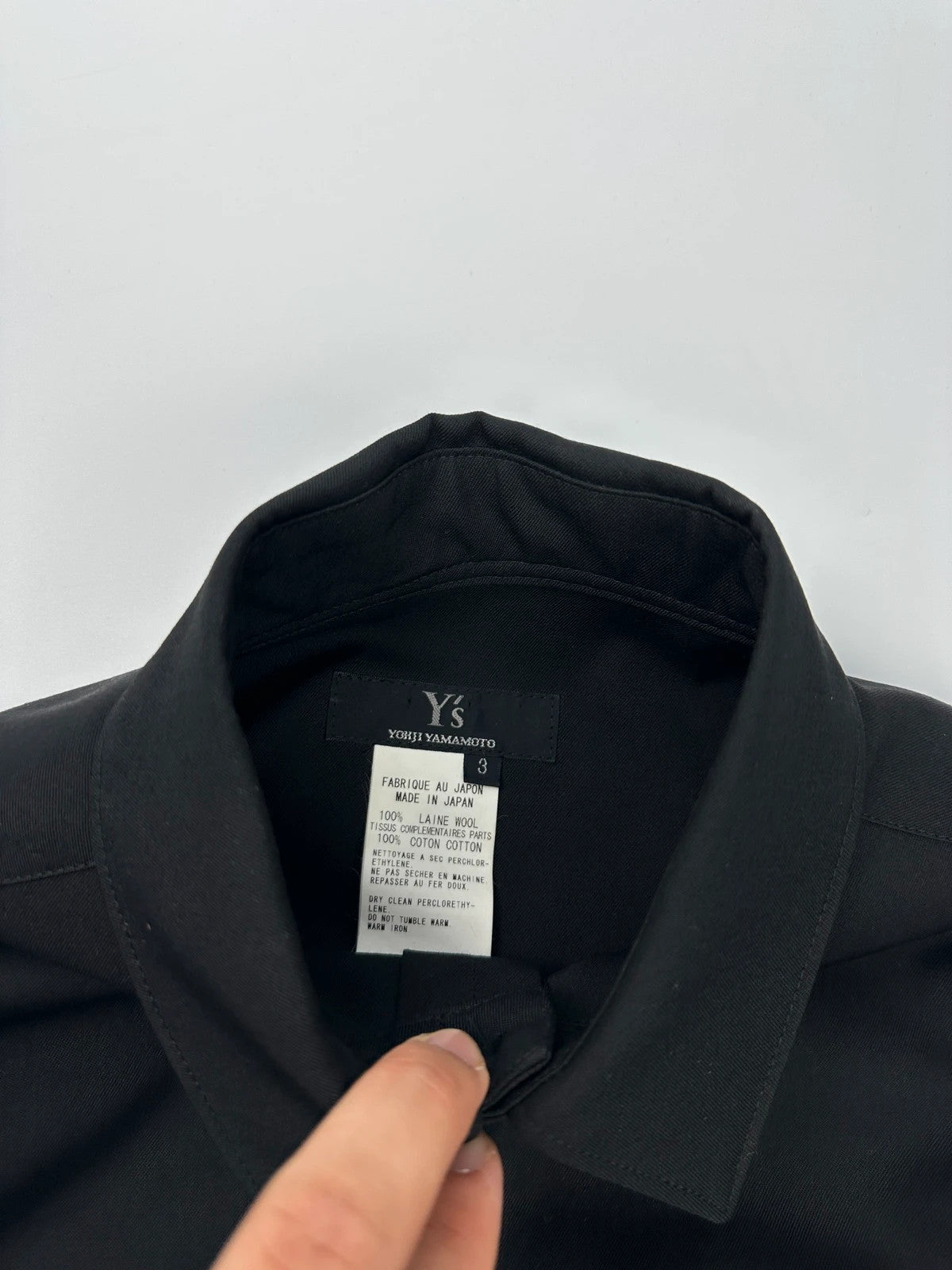Y's by Yohji Yamamoto black shirt with mesh sleeves and subtle logo details.