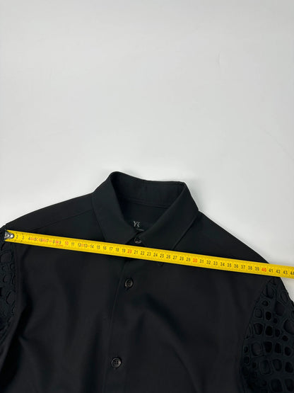 Y's by Yohji Yamamoto black shirt with mesh sleeves and subtle logo details.