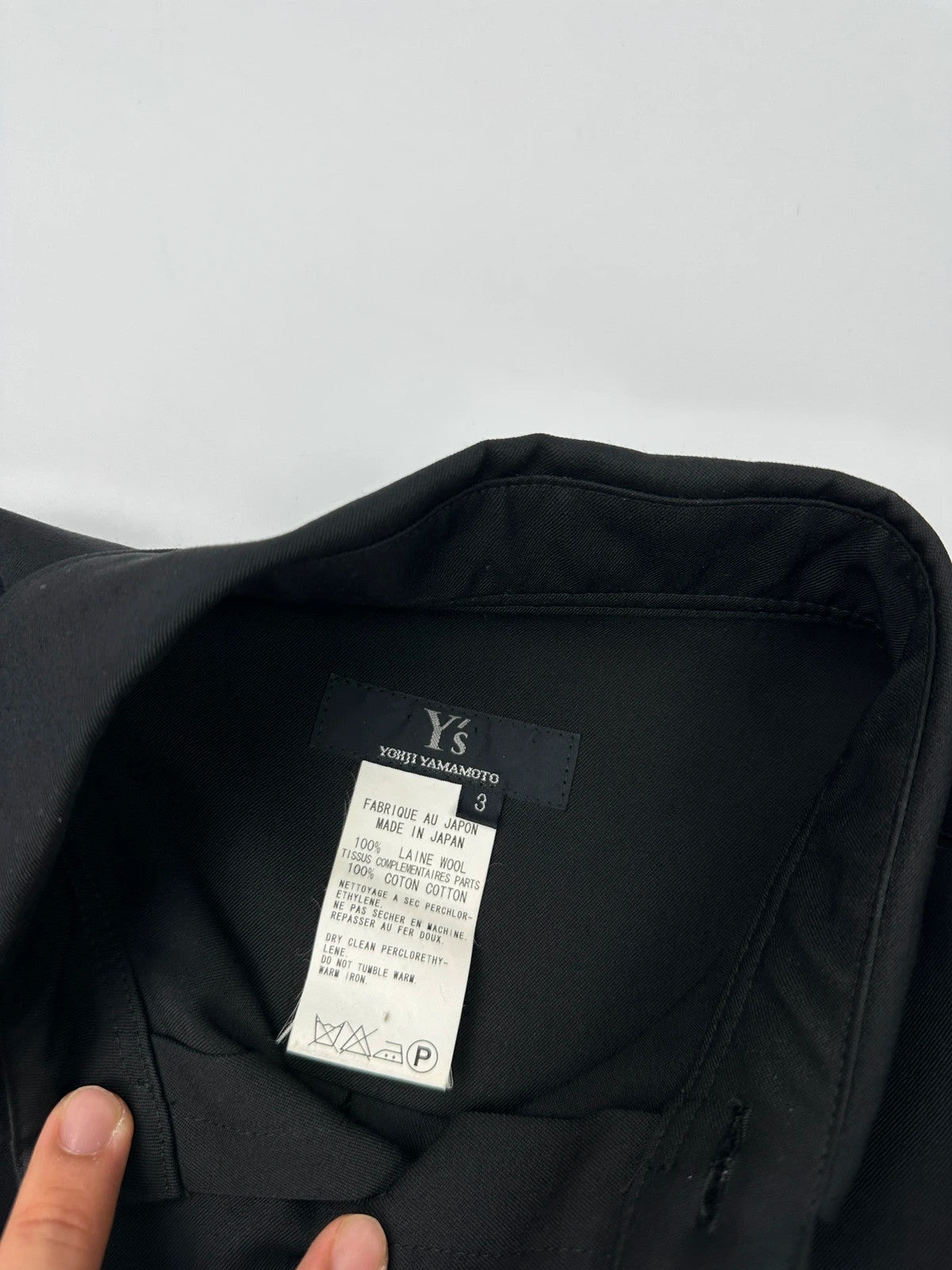Y's by Yohji Yamamoto black shirt with mesh sleeves and subtle logo details.