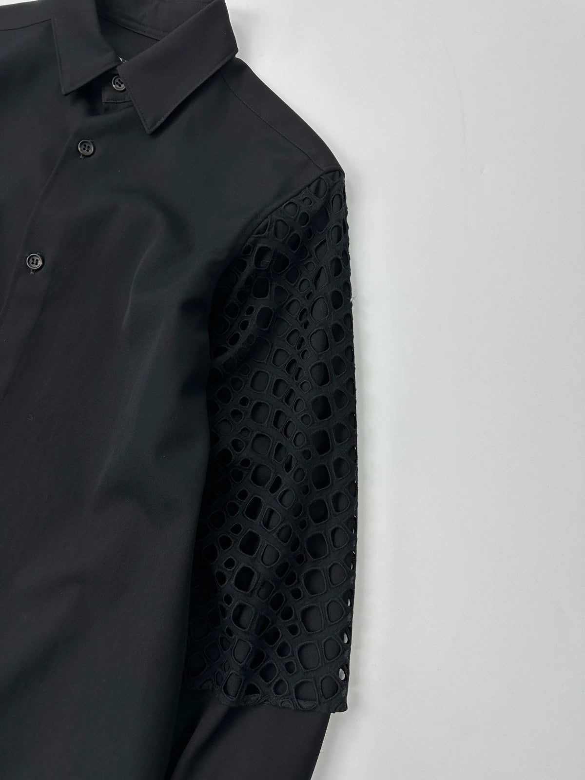 Y's by Yohji Yamamoto black shirt with mesh sleeves and subtle logo details.