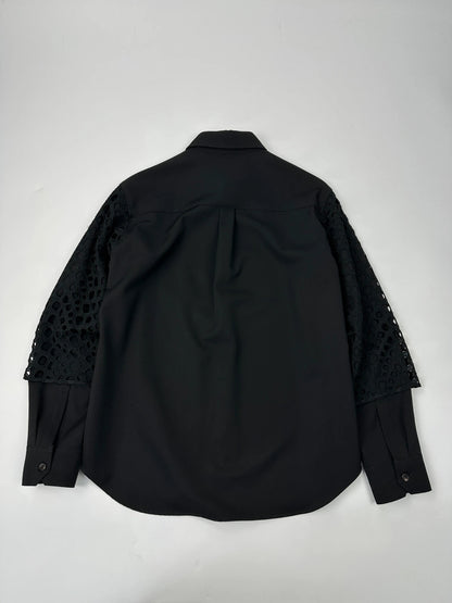 Y's by Yohji Yamamoto black shirt with mesh sleeves and subtle logo details.