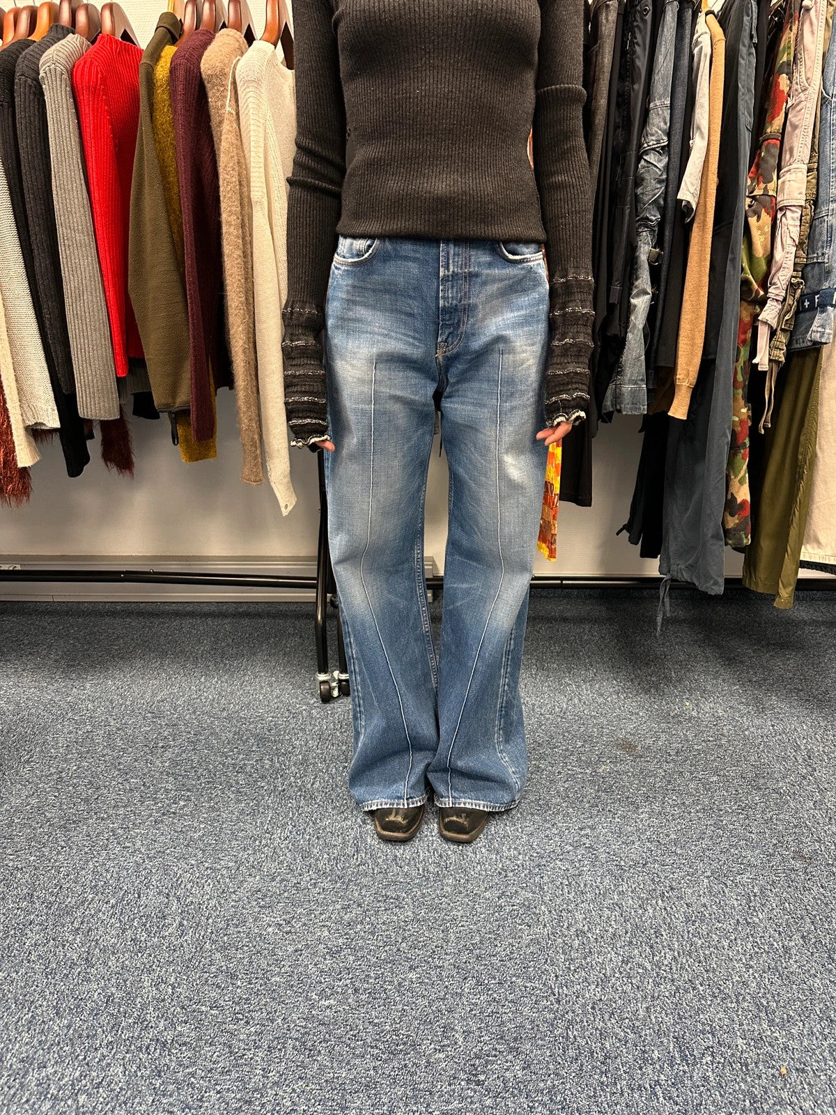 Acne Studios blue wide leg denim pants with subtle logo detailing and vintage style.