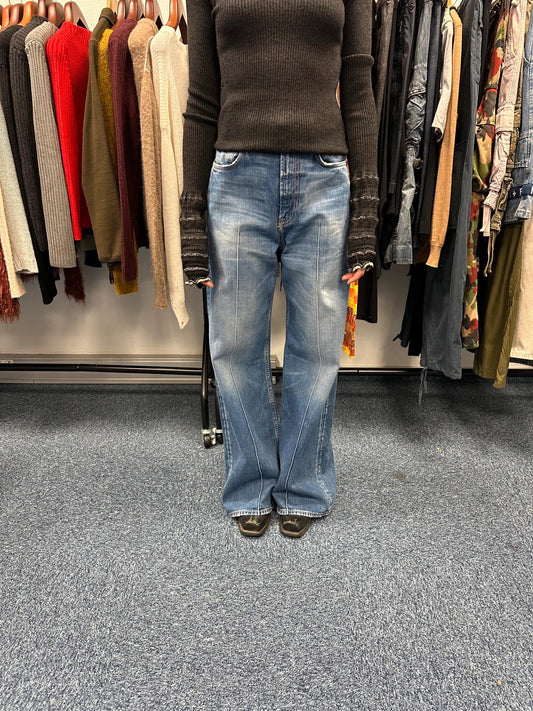 Acne Studios blue wide leg denim pants with subtle logo detailing and vintage style.
