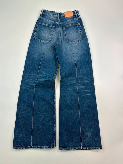 Acne Studios blue wide leg denim pants with subtle logo detailing and vintage style.