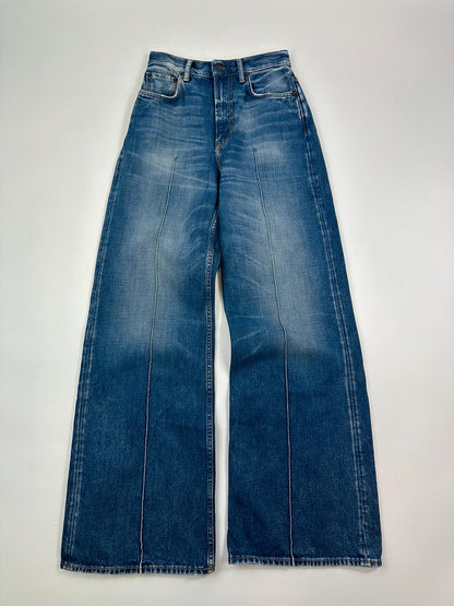 Acne Studios blue wide leg denim pants with subtle logo detailing and vintage style.