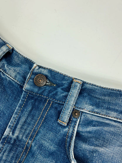 Acne Studios blue wide leg denim pants with subtle logo detailing and vintage style.