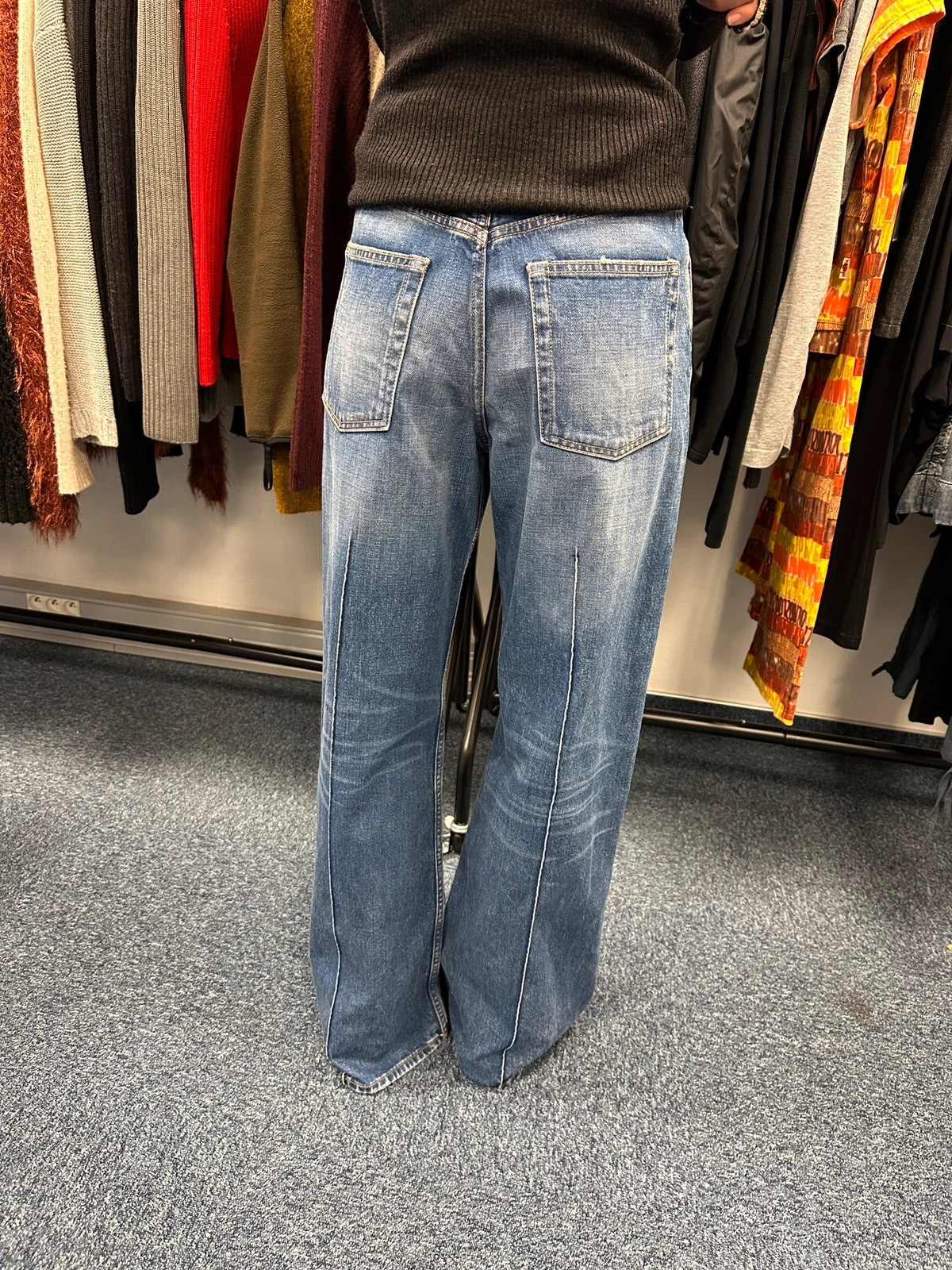 Acne Studios blue wide leg denim pants with subtle logo detailing and vintage style.