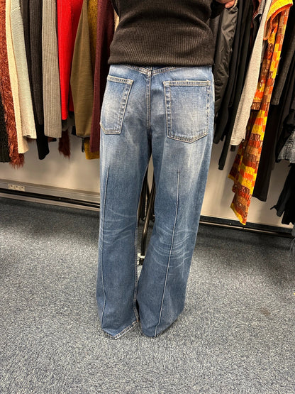 Acne Studios blue wide leg denim pants with subtle logo detailing and vintage style.
