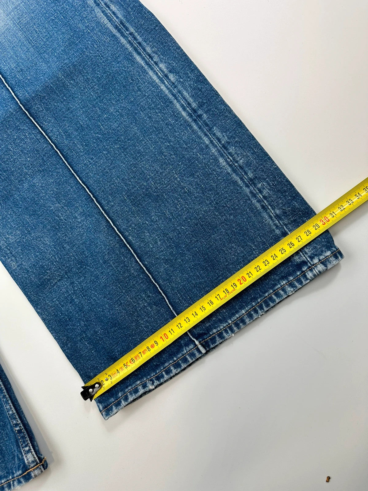Acne Studios blue wide leg denim pants with subtle logo detailing and vintage style.