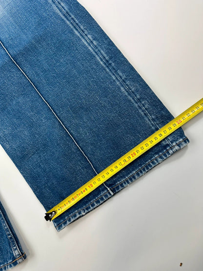 Acne Studios blue wide leg denim pants with subtle logo detailing and vintage style.