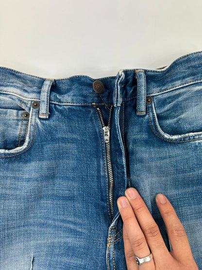 Acne Studios blue wide leg denim pants with subtle logo detailing and vintage style.