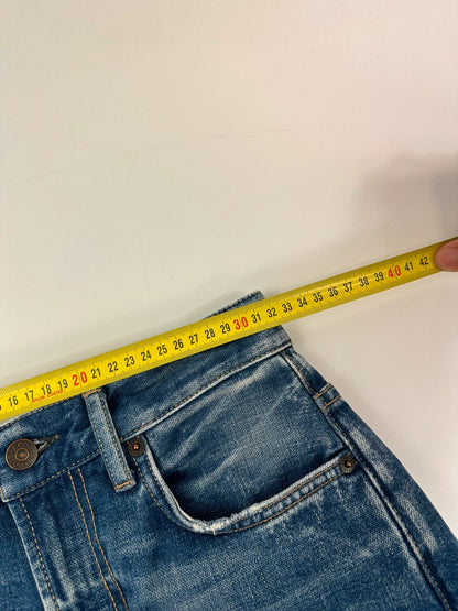 Acne Studios blue wide leg denim pants with subtle logo detailing and vintage style.
