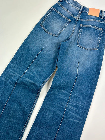 Acne Studios blue wide leg denim pants with subtle logo detailing and vintage style.