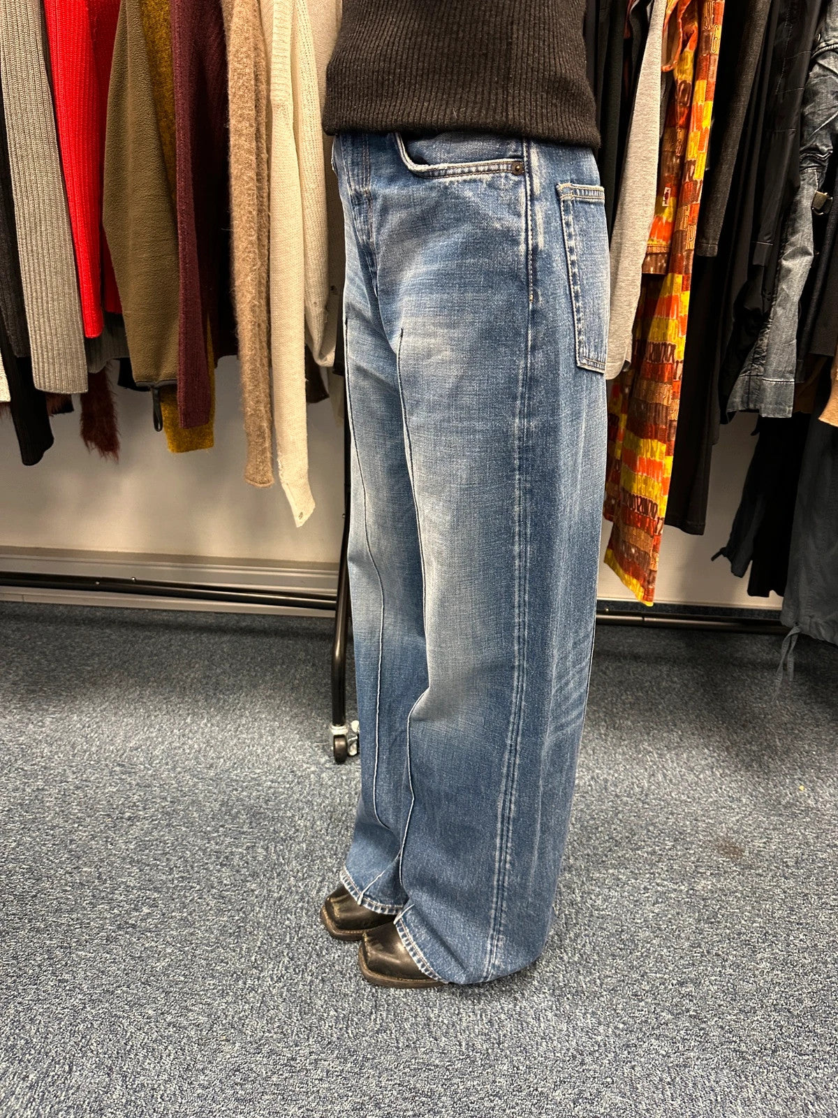 Acne Studios blue wide leg denim pants with subtle logo detailing and vintage style.