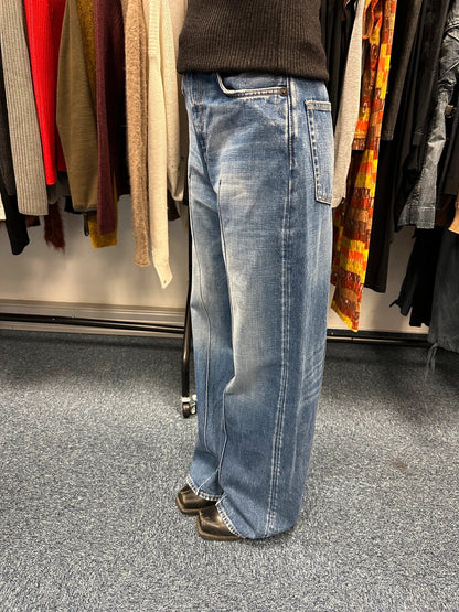 Acne Studios blue wide leg denim pants with subtle logo detailing and vintage style.