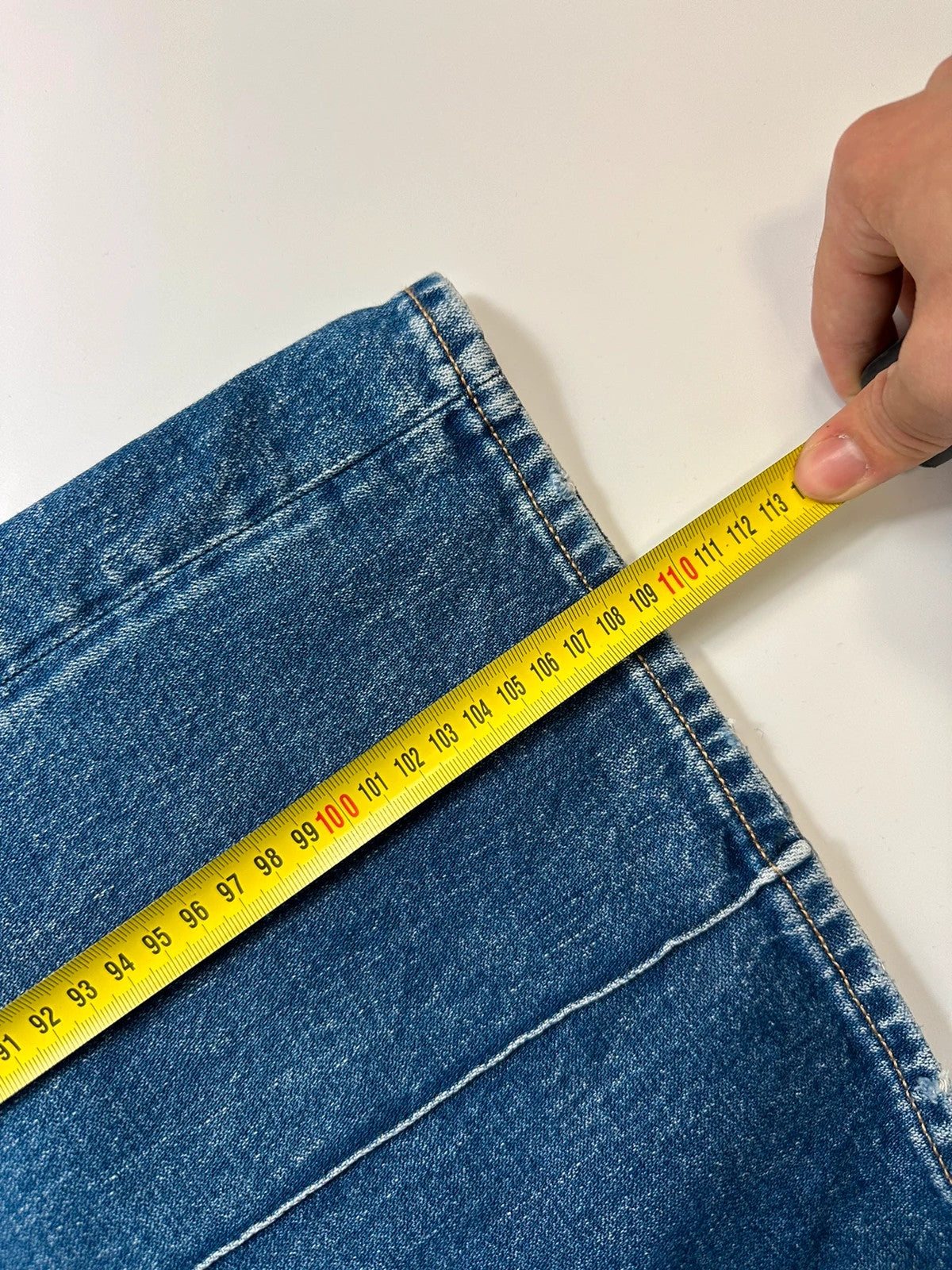 Acne Studios blue wide leg denim pants with subtle logo detailing and vintage style.