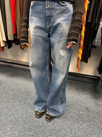 Acne Studios blue wide leg denim pants with subtle logo detailing and vintage style.