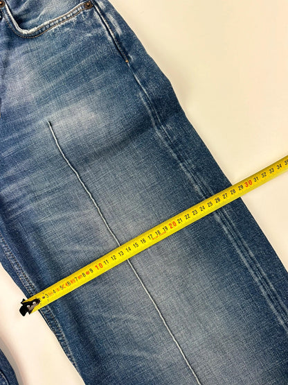 Acne Studios blue wide leg denim pants with subtle logo detailing and vintage style.