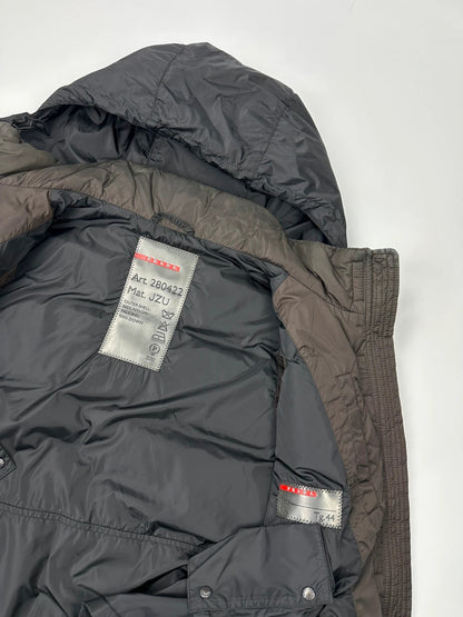 Prada brown puffer vest with retractable hood and linearossa logo details.