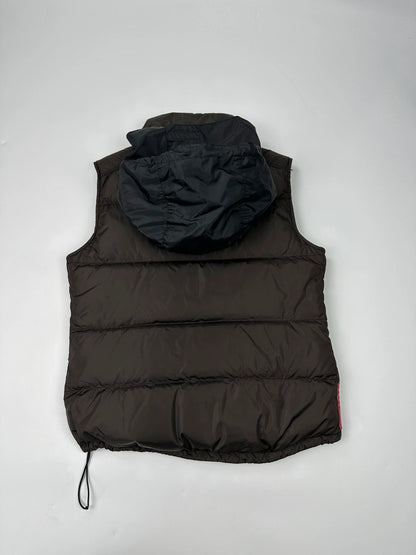 Prada brown puffer vest with retractable hood and linearossa logo details.