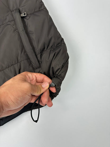 Prada brown puffer vest with retractable hood and linearossa logo details.