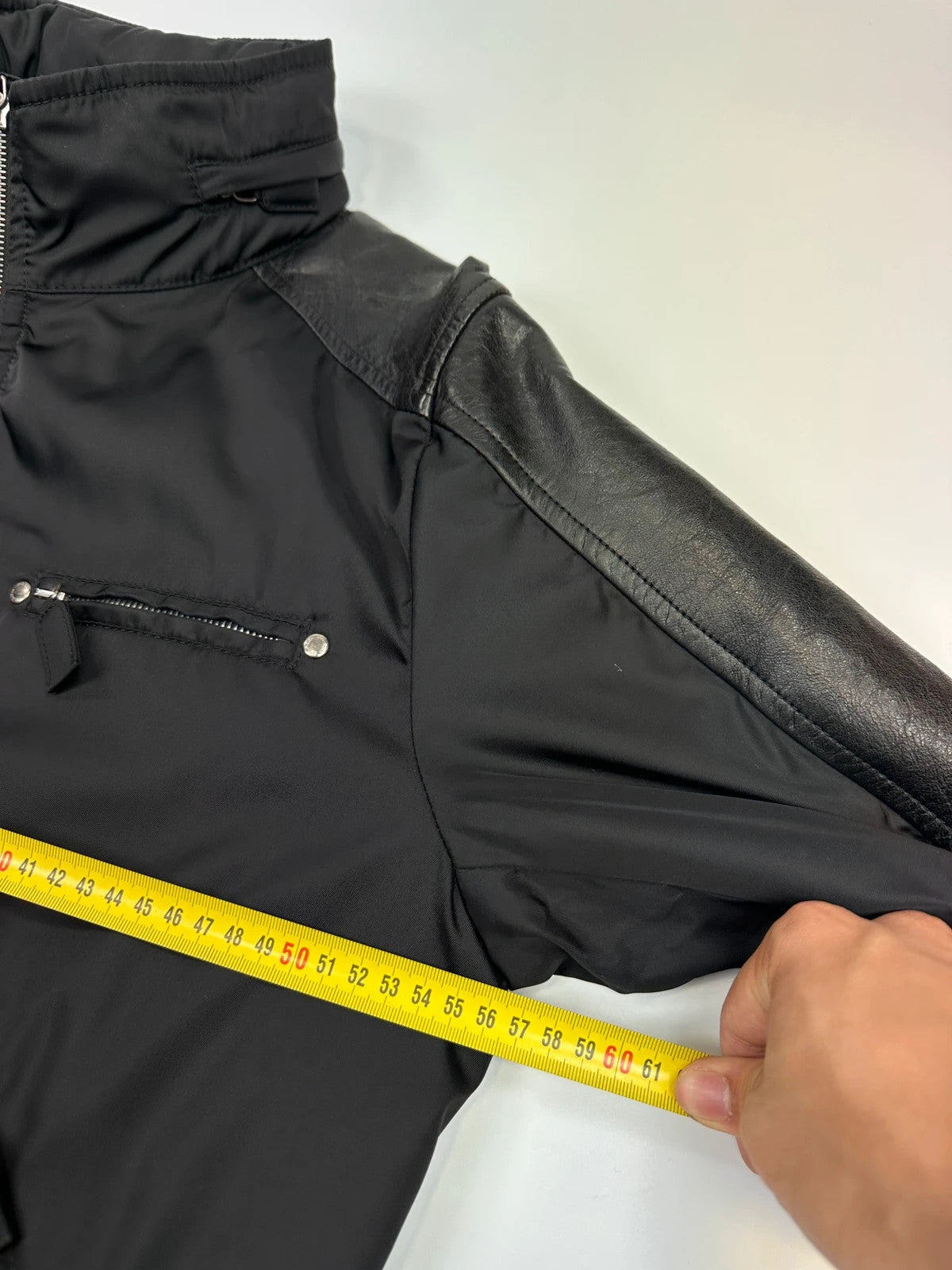 Prada black bomber jacket with leather details and hidden hood from FW2009 collection.