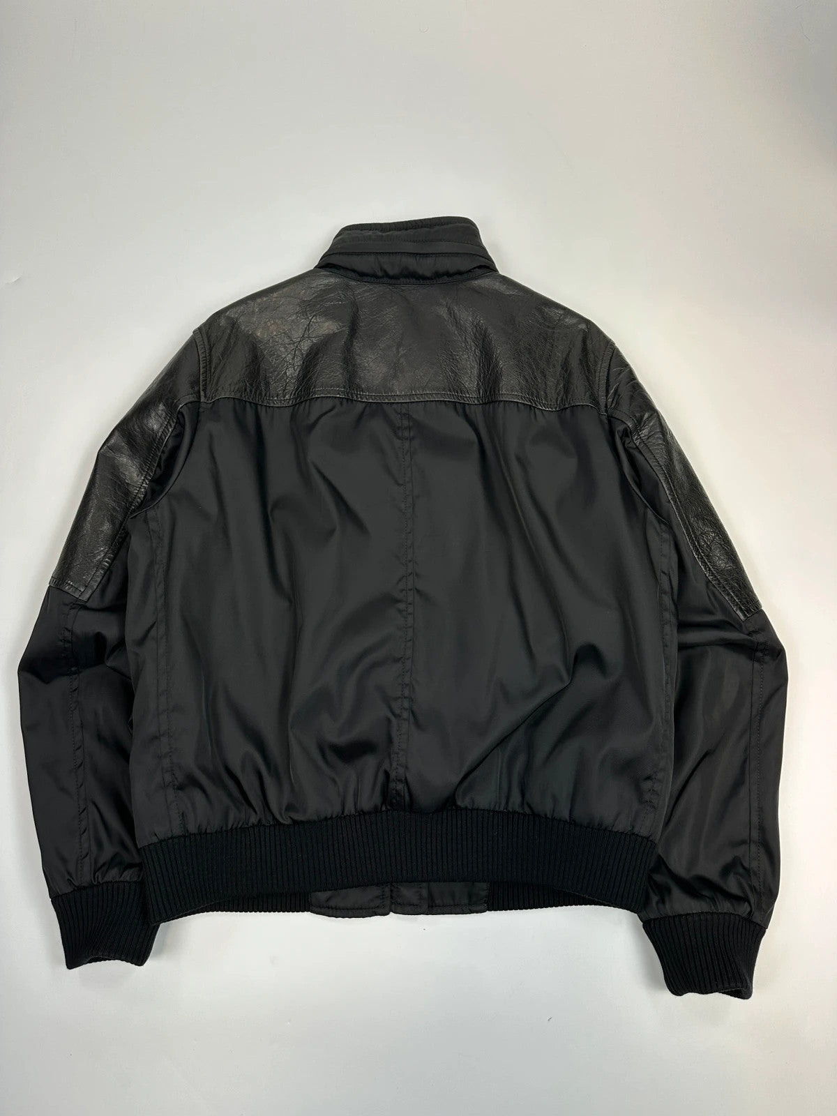 Prada black bomber jacket with leather details and hidden hood from FW2009 collection.