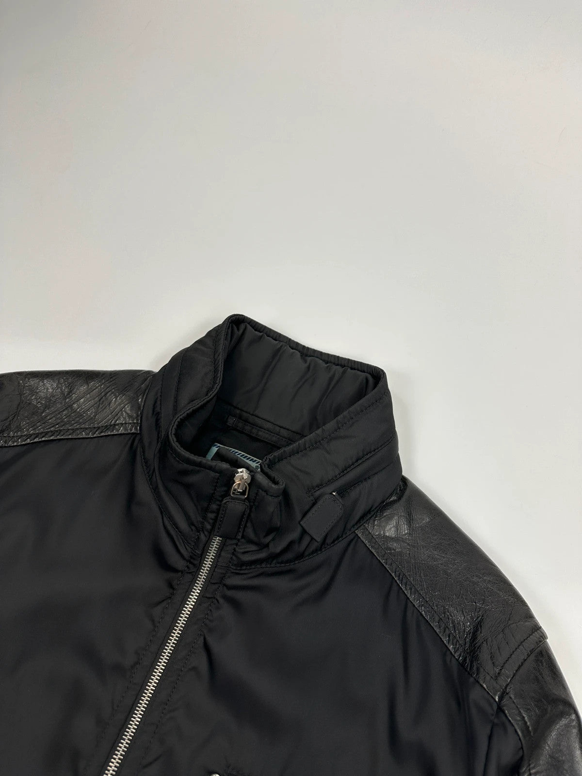 Prada black bomber jacket with leather details and hidden hood from FW2009 collection.
