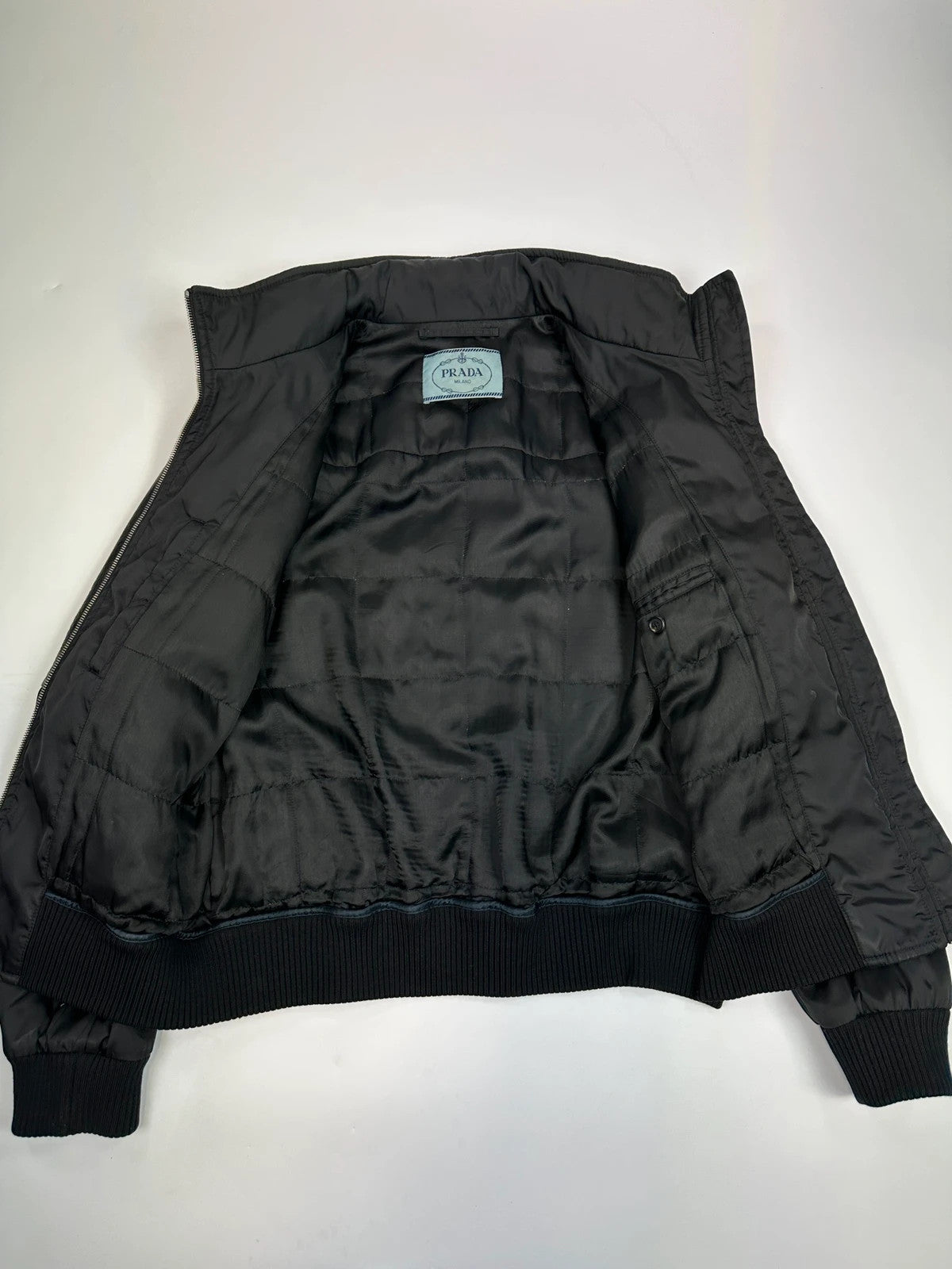Prada black bomber jacket with leather details and hidden hood from FW2009 collection.
