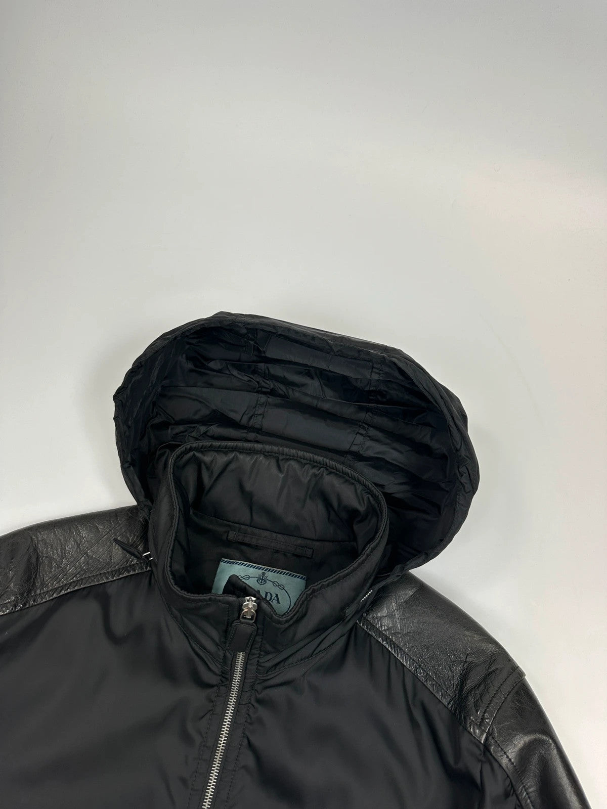Prada black bomber jacket with leather details and hidden hood from FW2009 collection.