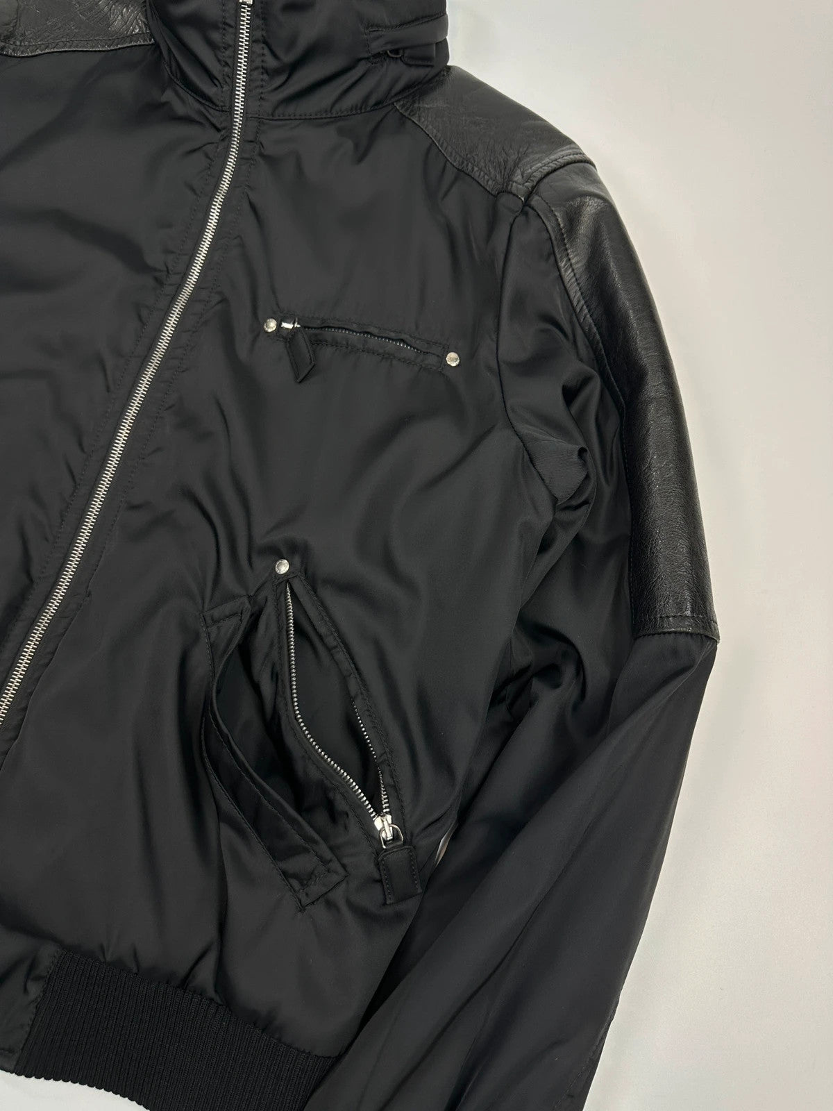 Prada black bomber jacket with leather details and hidden hood from FW2009 collection.