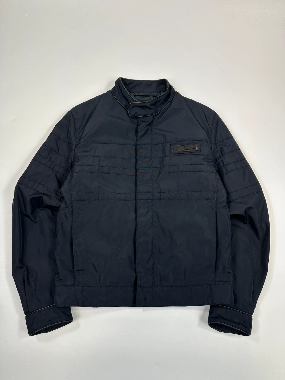 Prada bomber jacket navy blue nylon with reinforced details and minimalist design.